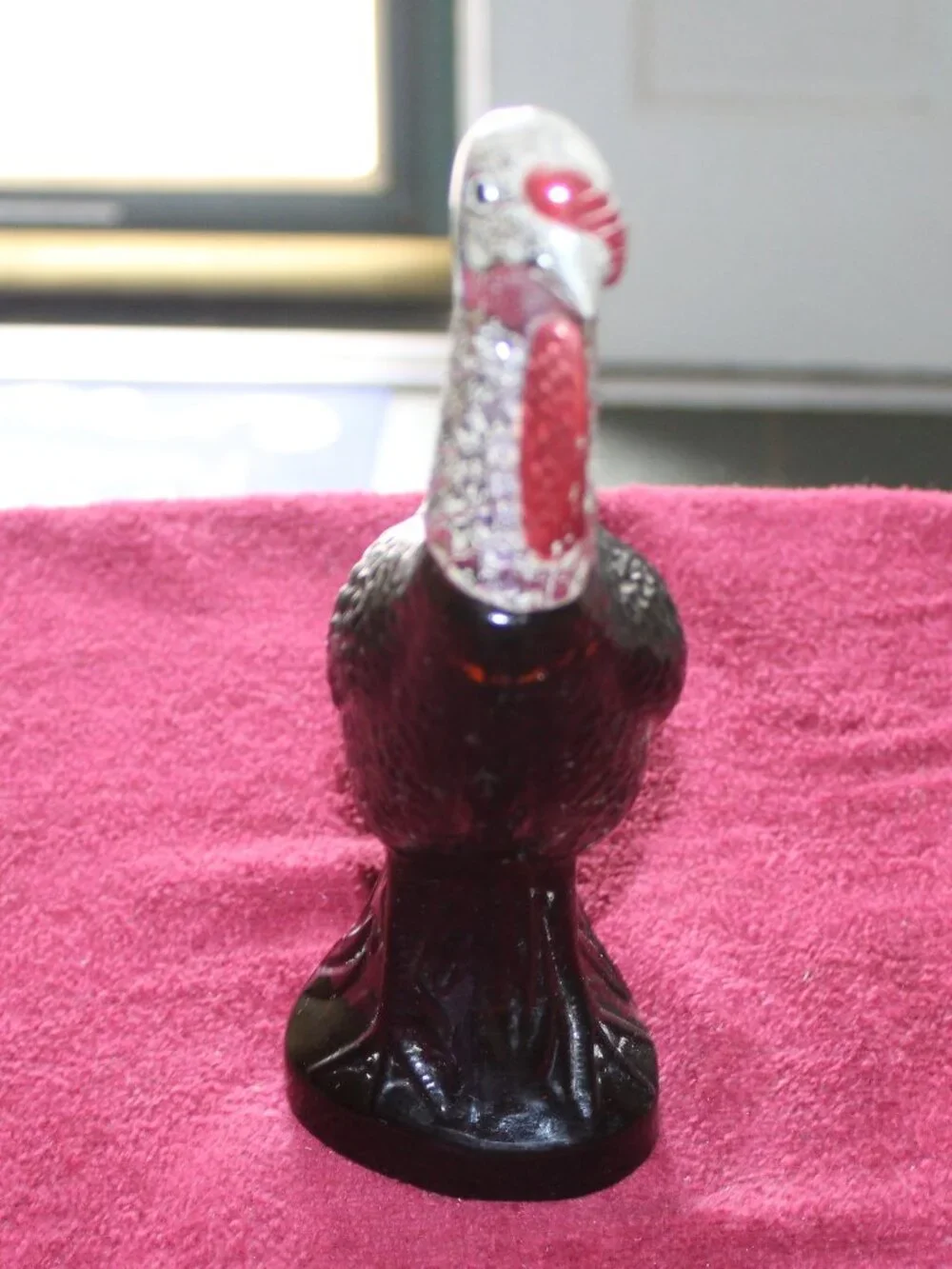 Vintage Avon Wild Turkey bottle, featuring brown glass and a silver-colored head